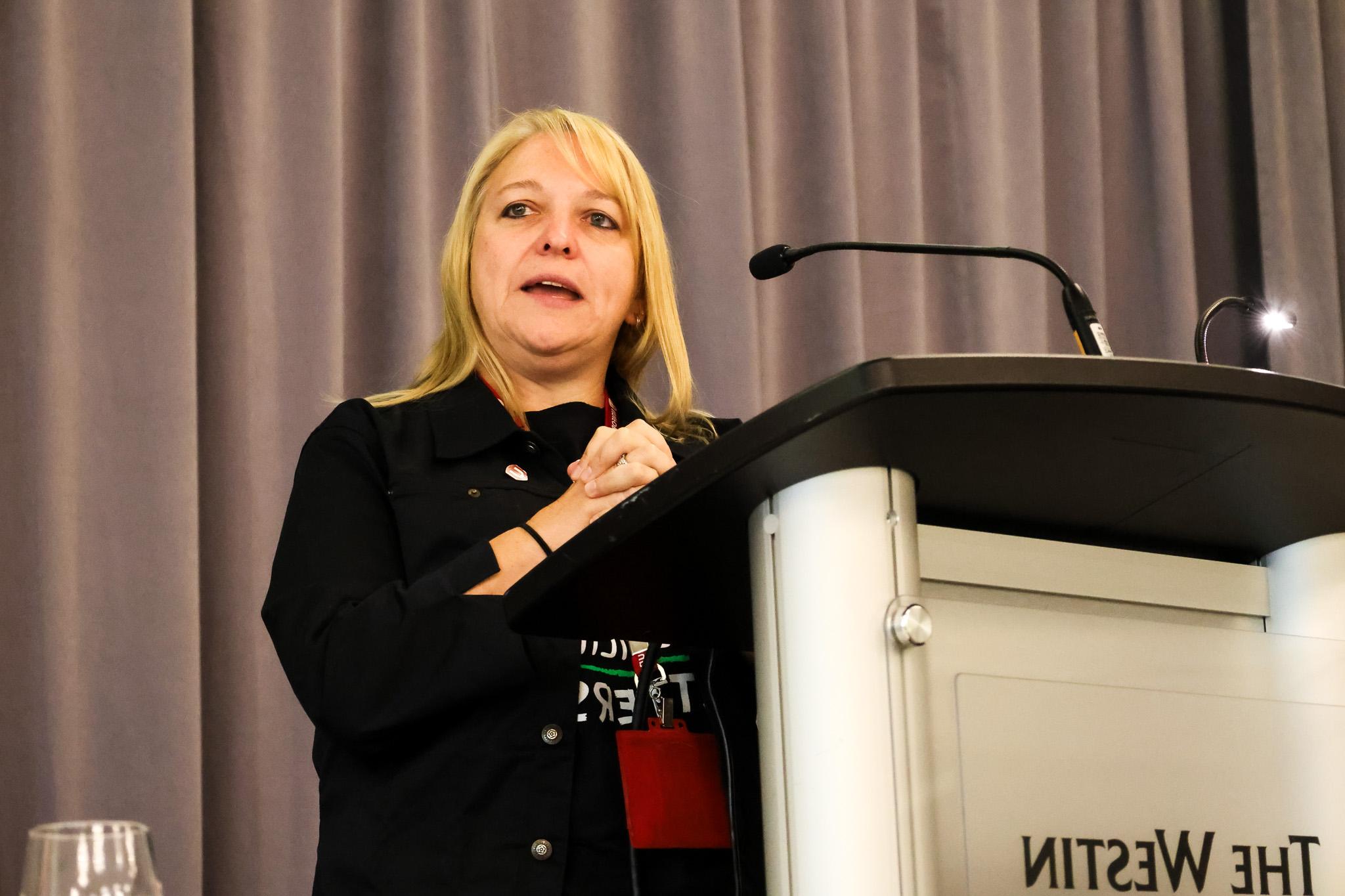 A women speaks at a podium